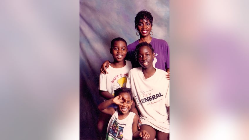 A young Robert Champion posing with his family in a portrait