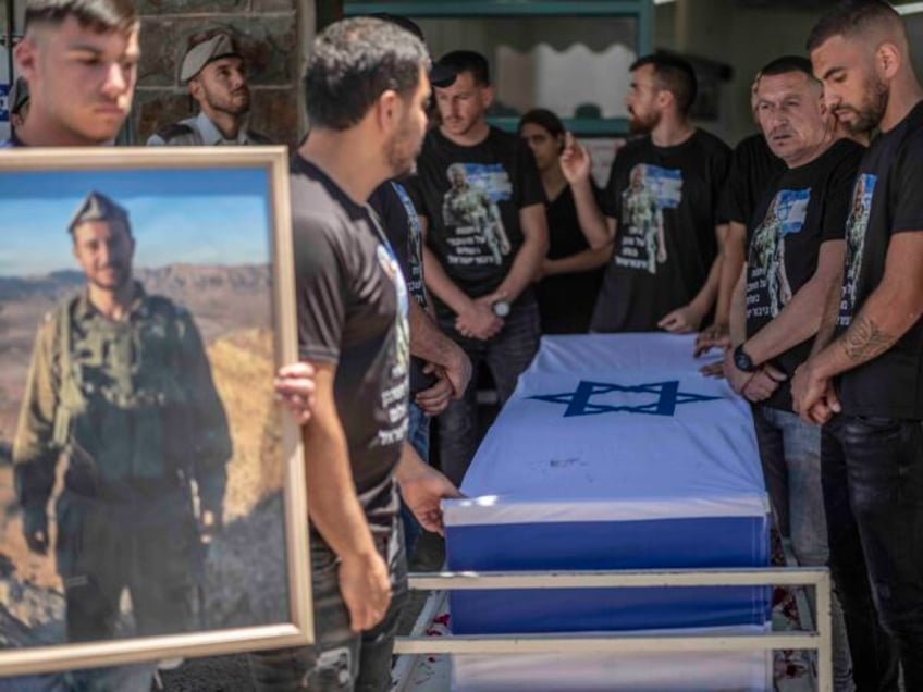 16 June 2024, Israel, Beit Jann: Friends and family mourn during the funeral of Israeli so