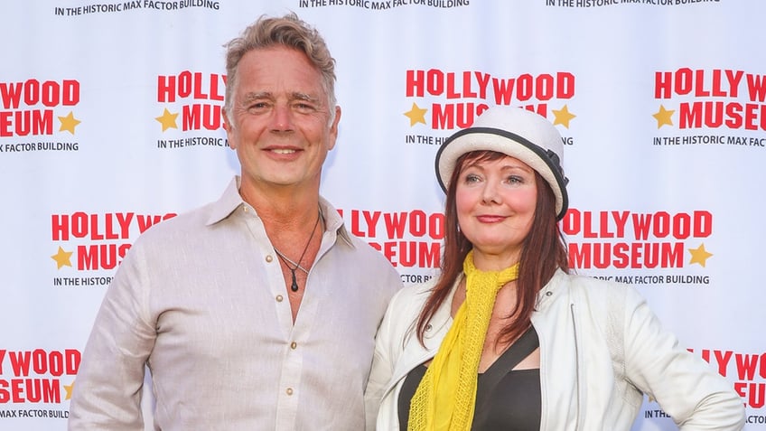 Actor John Schneider wears linen shirt with Dee Dee Sorvino by his side.