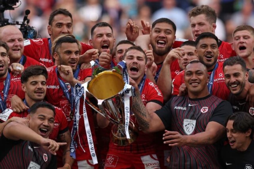 Joy of victory: Toulouse captain Antoine Dupont lifts the trophy after his side's extra-ti