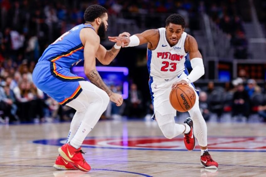 Detroit's Jaden Ivey drives past Kenrich Williams in the Pistons' NBA victory over the Oklahoma City Thunder