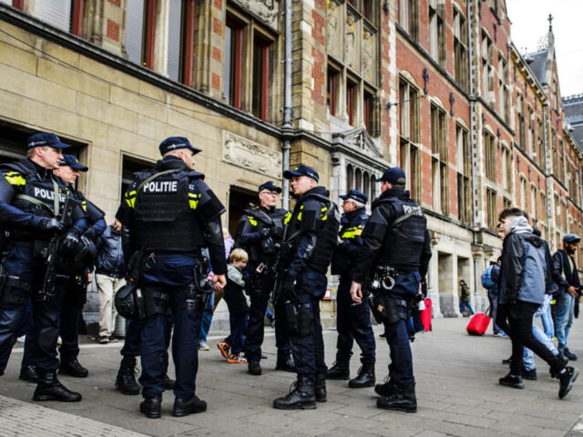 Dutch officers carry out extra patrols at the Central Station in Amsterdam, The Netherlands, 22 March 2016 following the triple bomb attacks in the Belgian capital that killed about 35 people. / AFP / ANP / Remko de Waal / Netherlands OUT (Photo credit should read REMKO DE WAAL/AFP via …