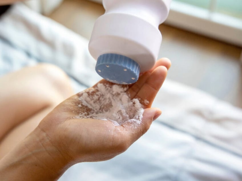 Healthy problem concept: baby powder in hand, dangerous for breath system - stock photo