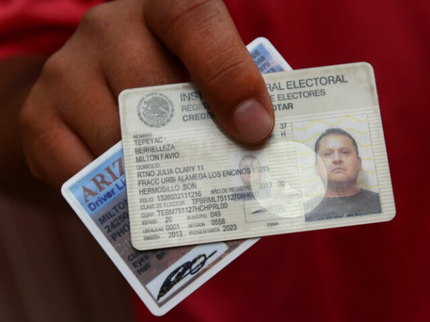 Milton Tepayac, 37, shows his former Arizona Driver's License now replaced by a new v