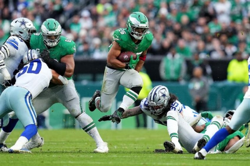 Saquon Barkley of the Philadelphia Eagles jumps over the tackle of Marist Liufau of the Da