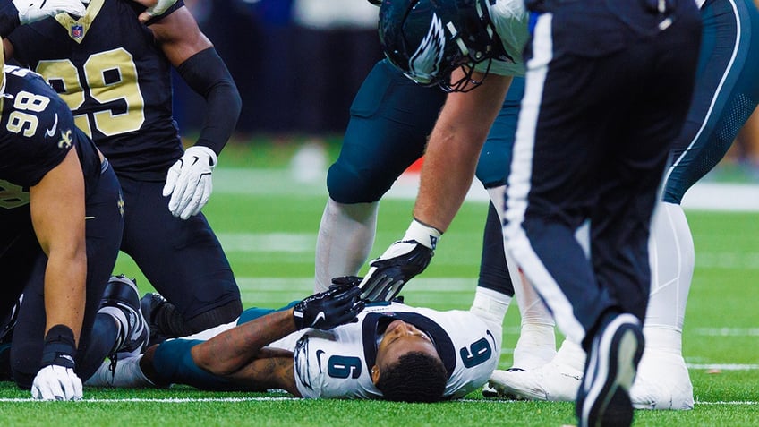 DeVonta Smith lays on turf