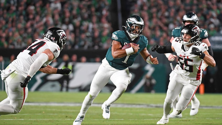 Jalen Hurts carries the football