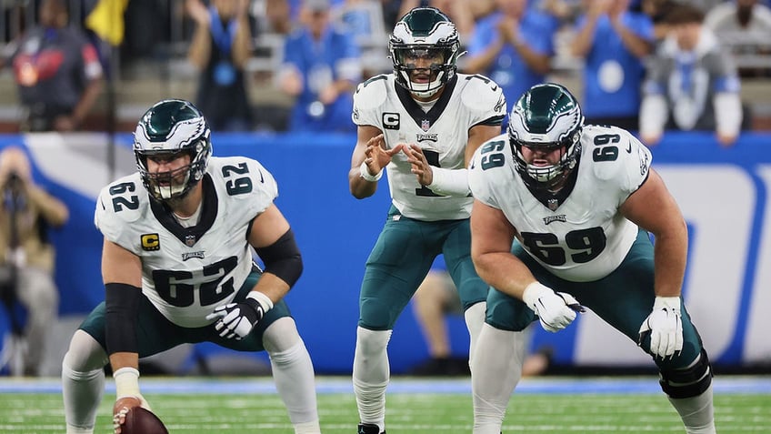 Jalen Hurts prepares to catch the snap by center Jason Kelce