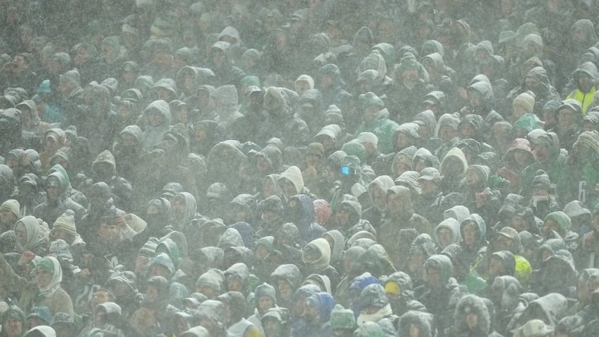 Fans look on in the snow during the fourth quarter between the Philadelphia Eagles and the Los Angeles Rams in the NFC Divisional Playoff at Lincoln Financial Field on January 19, 2025 in Philadelphia, Pennsylvania. 