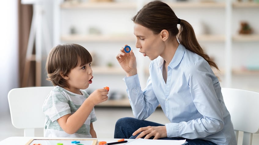 speech therapist and little boy