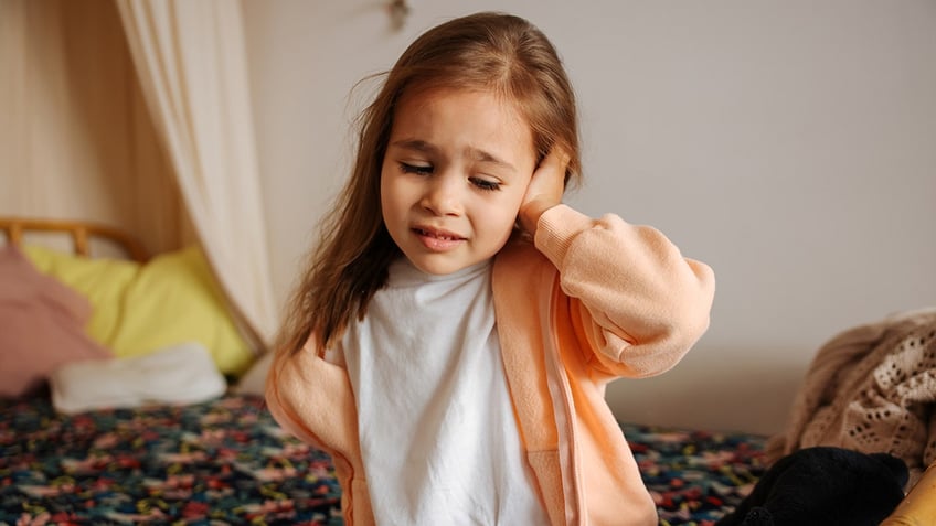 little girl with ear infection