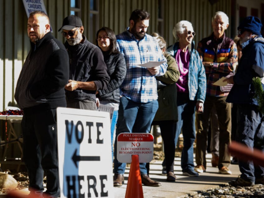 A line of voters waits outside an early voting site on October 17, 2024 in Black Mountain,