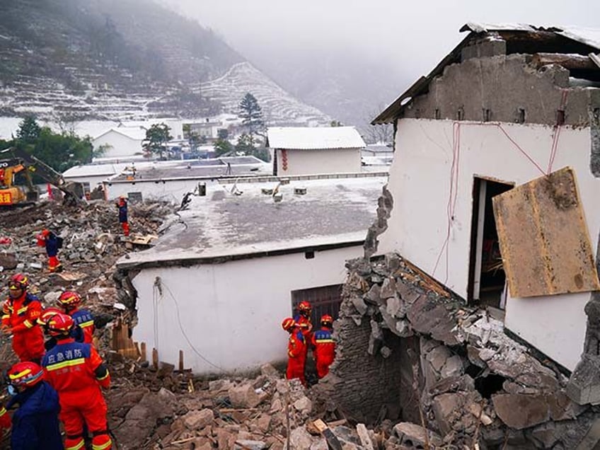 Rescue workers search for missing victims at a damaged house following a landslide in Liangshui village at Zhaotong, in southwestern China's Yunnan province on January 23, 2024. (Photo by CNS / AFP) / China Out (Photo by STR/CNS/AFP via Getty Images)