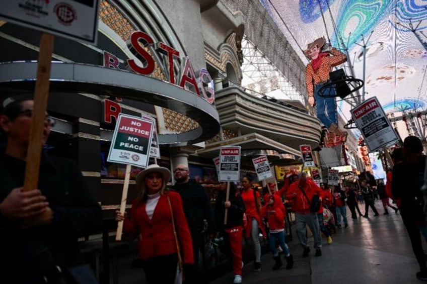 Supporters of the Culinary Workers Union carry picket signs calling for a fair contract ou