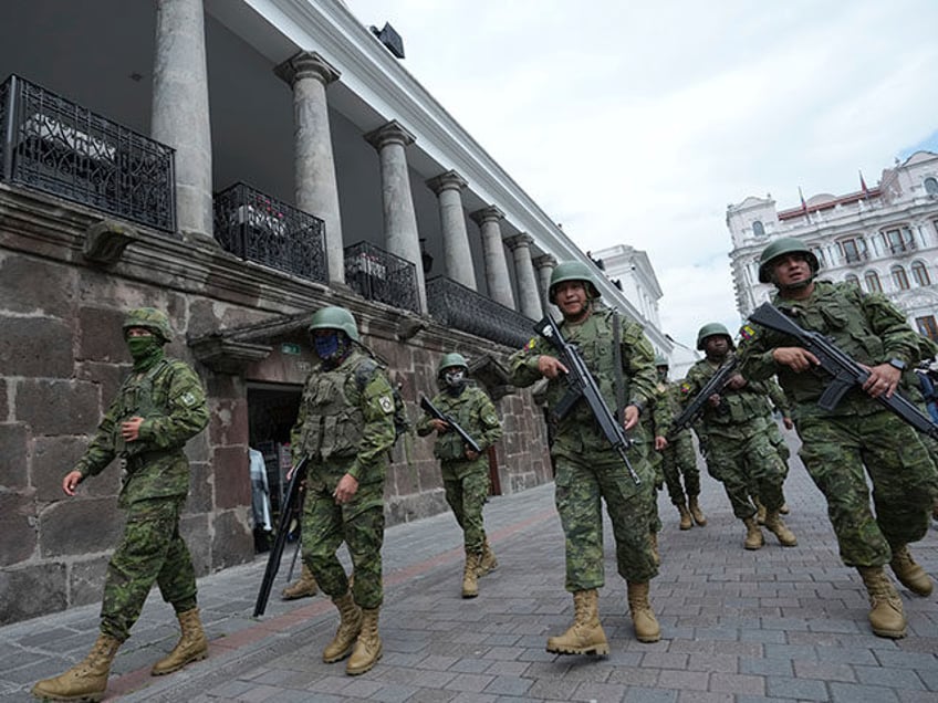 Soldiers patrol outside the government palace during a state of emergency in Quito, Ecuador, Tuesday, Jan. 9, 2024. The country has seen a series of attacks after the government imposed a state of emergency in the wake of the apparent escape of a powerful gang leader from prison. (AP Photo/Dolores …