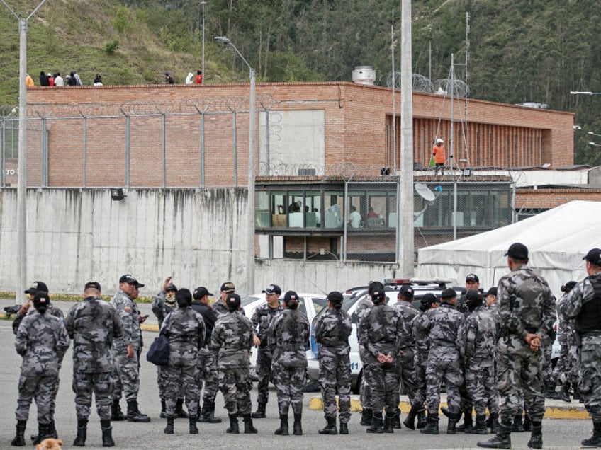 Police forces stand guard outside the Turi prison as inmates hold prison guards hostage, in Cuenca, Ecuador, on January 8, 2024. The leader of Ecuador's main criminal gang Adolfo Macías, alias "Fito", is thought to have escaped on January 7 "hours before" an operation at the prison where he was …