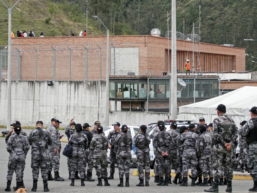 Police forces stand guard outside the Turi prison as inmates hold prison guards hostage, in Cuenca, Ecuador, on January 8, 2024. The leader of Ecuador's main criminal gang Adolfo Macías, alias "Fito", is thought to have escaped on January 7 "hours before" an operation at the prison where he was serving his sentence, Communication Secretary General Roberto Izurieta said on Monday. Following the escape of the head of the Los Choneros drug gang, incidents were reported in several of the country's prisons. (Photo by Fernando MACHADO / AFP) (Photo by FERNANDO MACHADO/AFP via Getty Images)