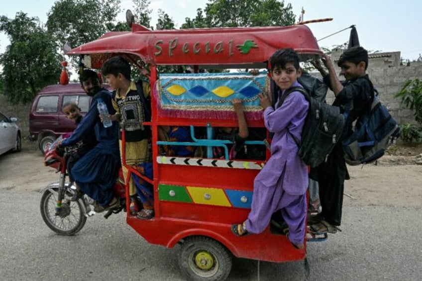 Students travel home from a community school in Abdullah Goth village on the outskirts of