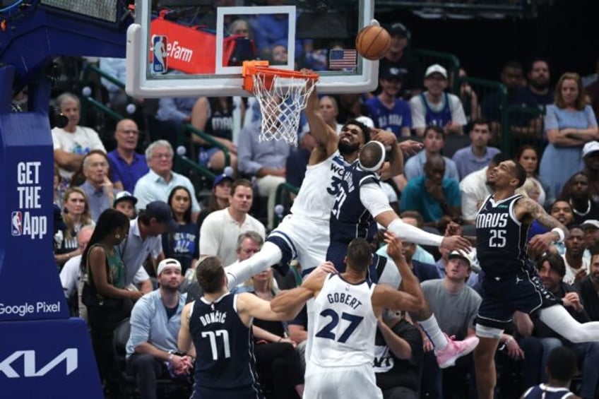 Minnesota's Karl-Anthony Towns (32) shoots over Dallas's Daniel Gafford in Wednesday's Wes