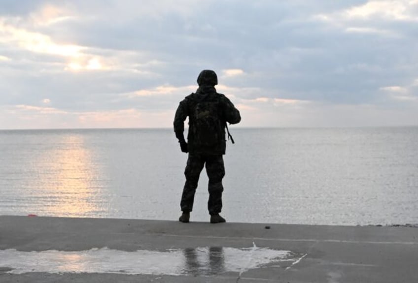 A South Korean marine patrols a beach on Yeonpyeong Island