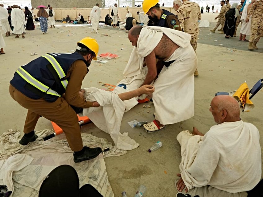 Paramedics carry a muslim pilgrim for a medical check after he fell down due to a heat stroke at pillars, in Mina, near the holy city of Mecca, Saudi Arabia, Sunday, June 16, 2024. Masses of pilgrims on Sunday embarked on a symbolic stoning of the devil in Saudi Arabia. The ritual marks the final days of the Hajj, or Islamic pilgrimage, and the start of the Eid al-Adha celebrations for Muslims around the world. (AP Photo/Rafiq Maqbool)