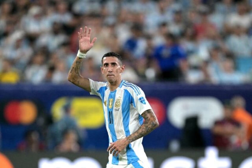 Argentina's Angel Di Maria acknowledges supporters as he leaves the pitch after being subs