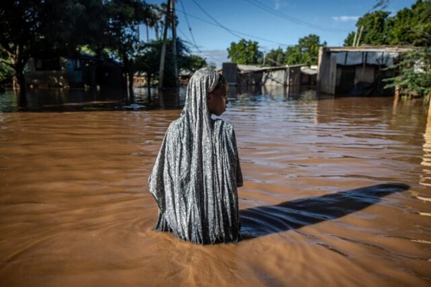 A woman wades through floodwaters in Garissa, Kenya earlier this month