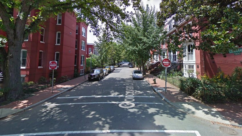 Do not enter signs in front of street, trees, cars parked along roads by apartments/homes on 1300 Corcoan St NW in Washington, DC