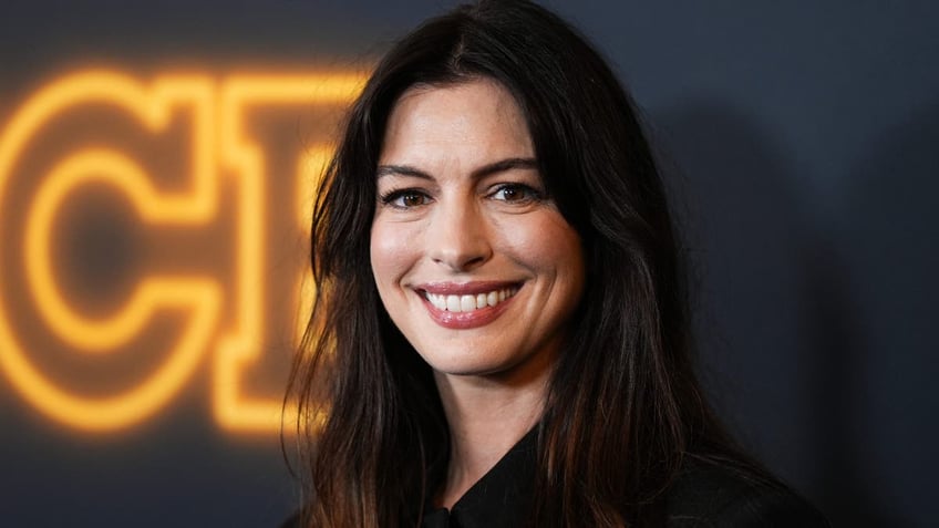 anne hathaway smiling on red carpet