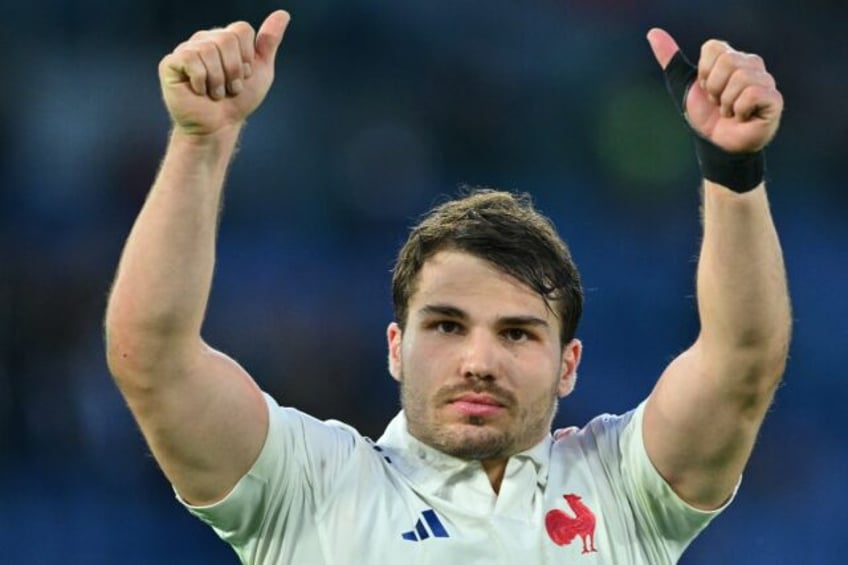 Twice as good: France scrum-half Antoine Dupont, who scored two tries, celebrates victory