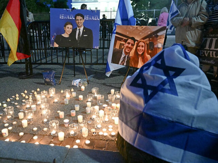 People attend a candlelight vigil at Lafayette Square across from the White House in Washi