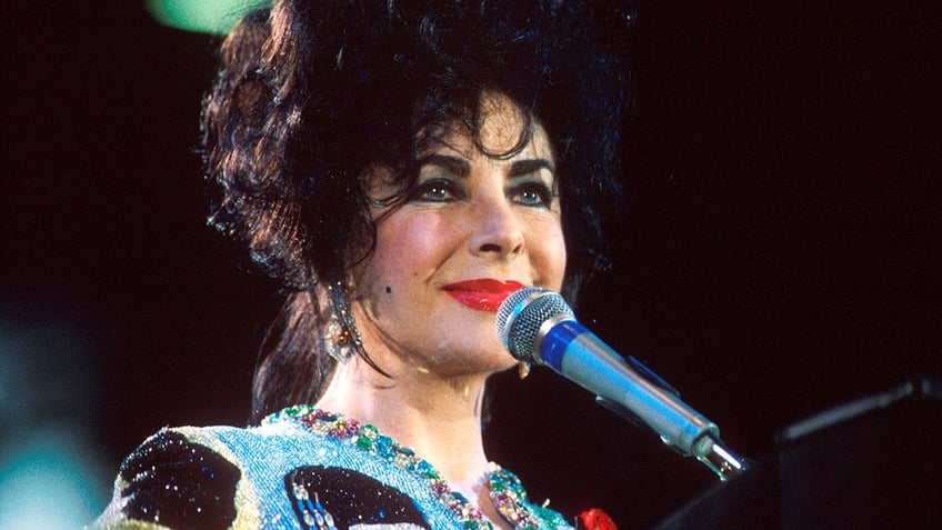 A close-up of Elizabeth Taylor wearing a sparkly blazer.