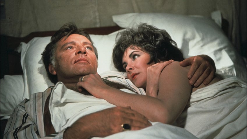 Elizabeth Taylor in bed with Richard Burton.