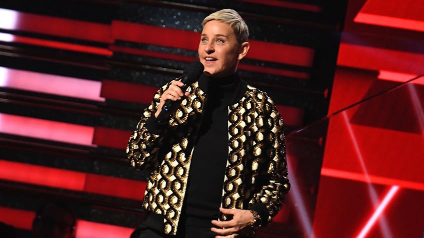 Ellen DeGeneres on stage with microphone in her hand