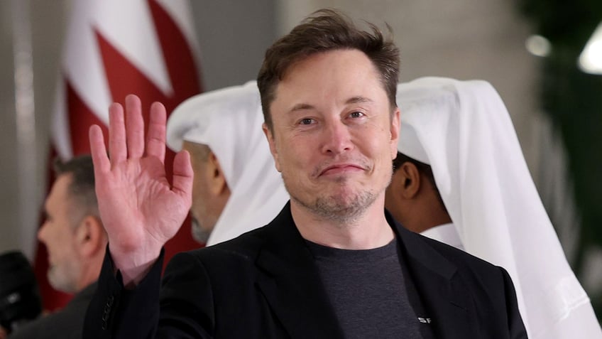 Elon Musk waves
