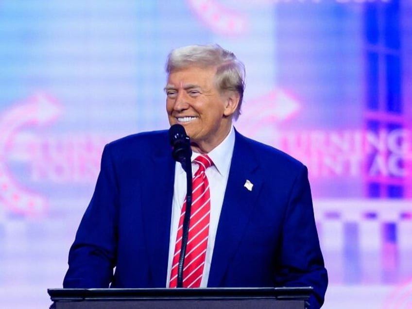 Donald Trump smiles at the podium