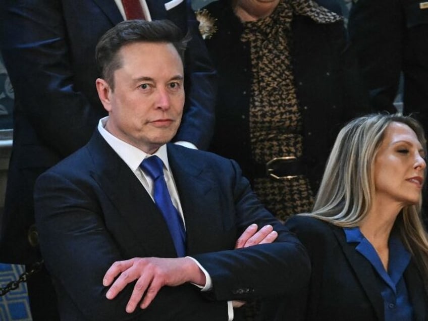 Elon Musk with arms crossed