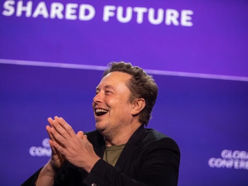 Elon Musk laughing with glee