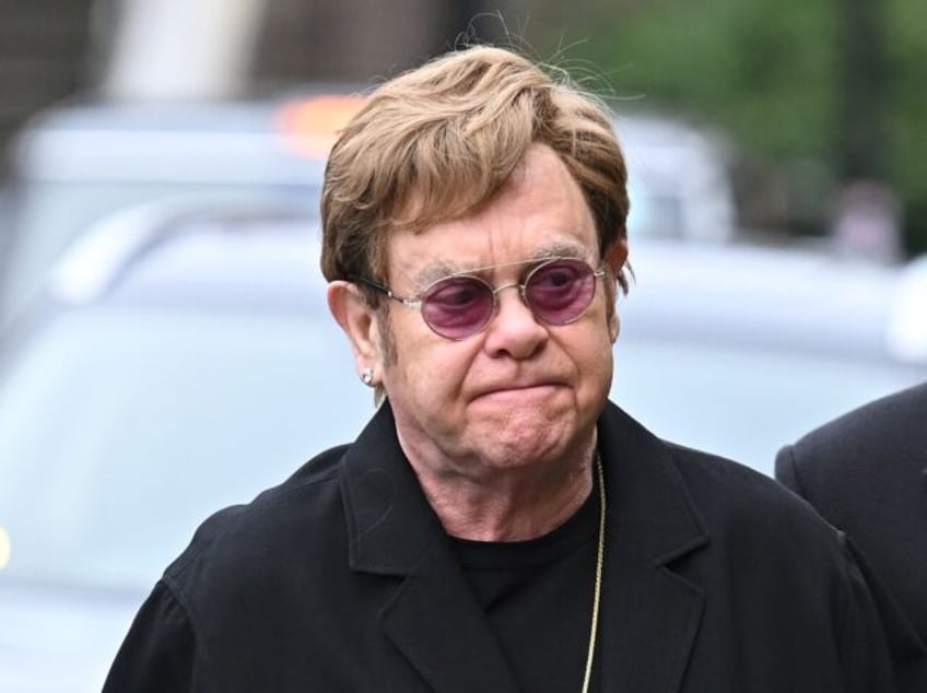 LONDON, ENGLAND - FEBRUARY 2: Elton John and David Furnish attend the funeral of Derek Dra