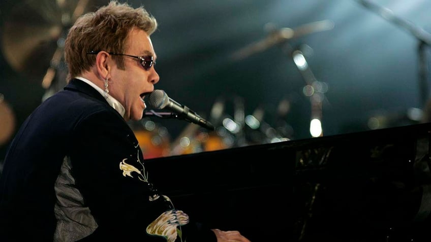 Elton John performs on stage