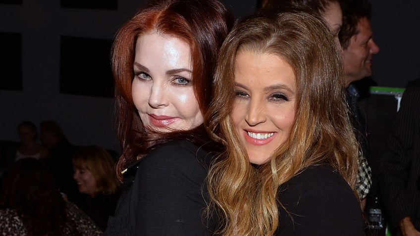 Priscilla Presley and Lisa Marie smile while standing together