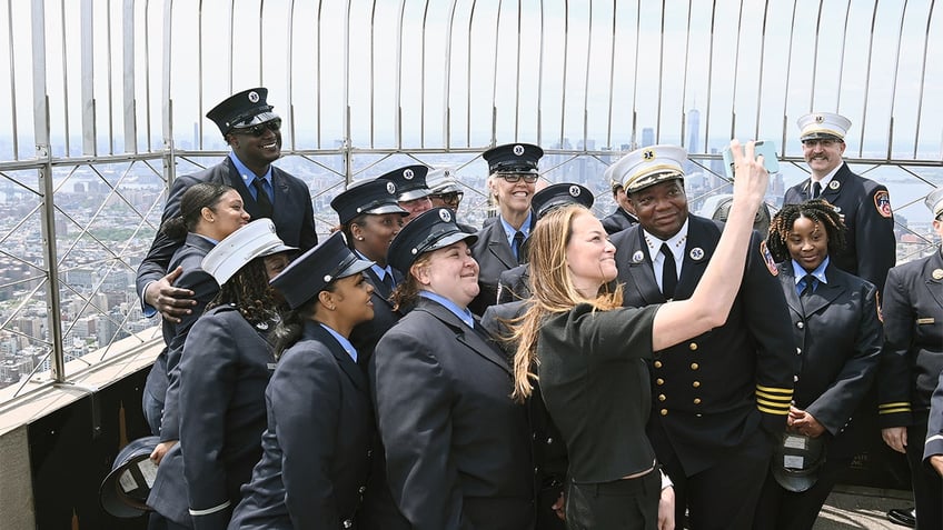 FDNY Commissioner Kavanagh taking a selfie with members of the FDNY atop the Empire State Building