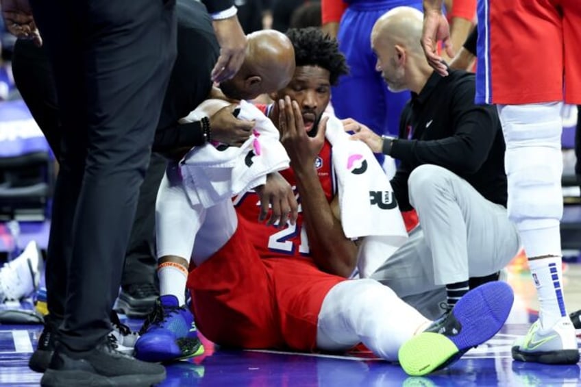 Philadelphia 76ers star Joel Embiid is attended by medical staff after taking a blow to th