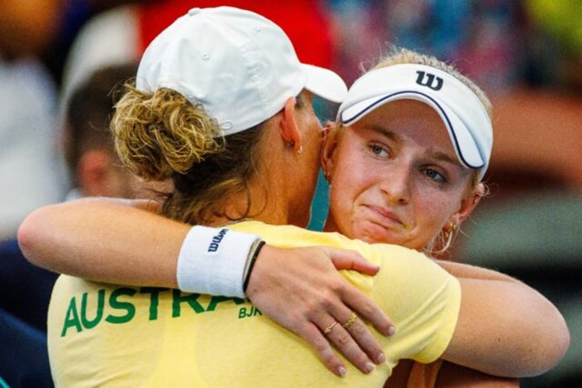 Australia's Taylah Preston (R) is embraced by team captain Samantha Stosur