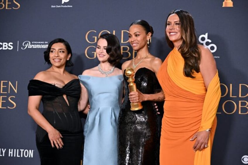 The "Emilia Perez" cast pose with the Golden Globe Award for Best Motion Picture – Musi