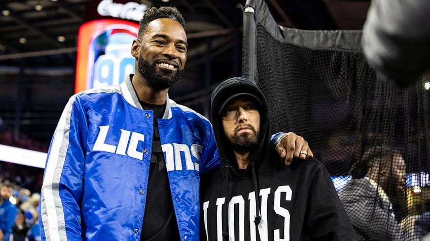 Eminem with Calvin Johnson on field