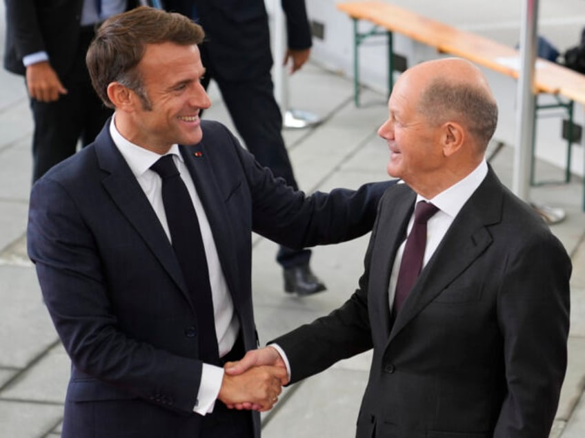 German Chancellor Olaf Scholz, right, welcomes French President Emmanuel Macron for a meet