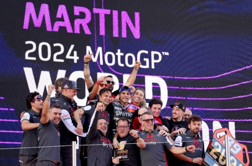 New world champion Jorge Martin (C) surrounded by his Ducati-Pramac team after becoming th