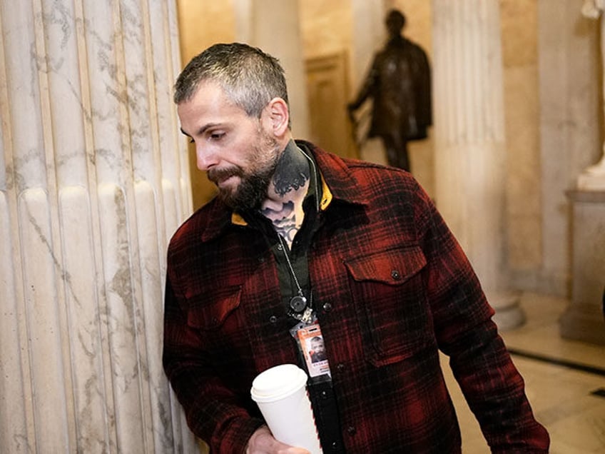 Washington Metropolitan Police Department officer Michael Fanone arrives in the Hall of Co