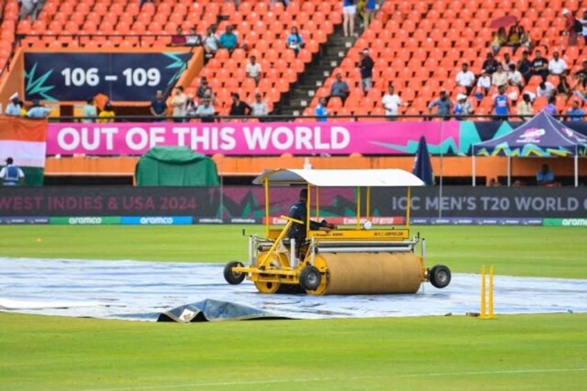 Delayed start: Groundstaff mop up after rain delayed the start of the T20 World Cup semi-f